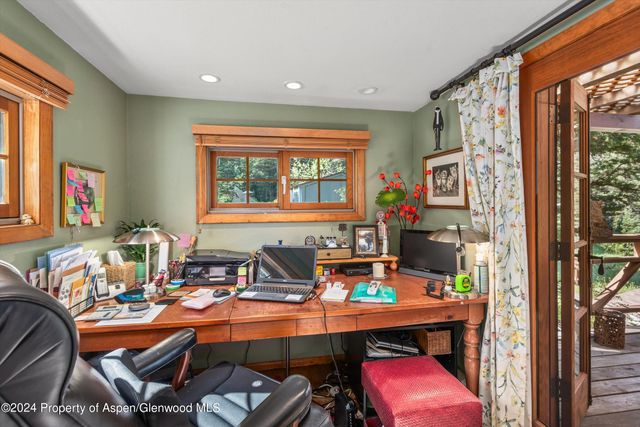 a room with musical instrument pool table and windows