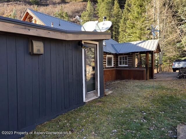 a view of a house with a barbeque and wooden fence