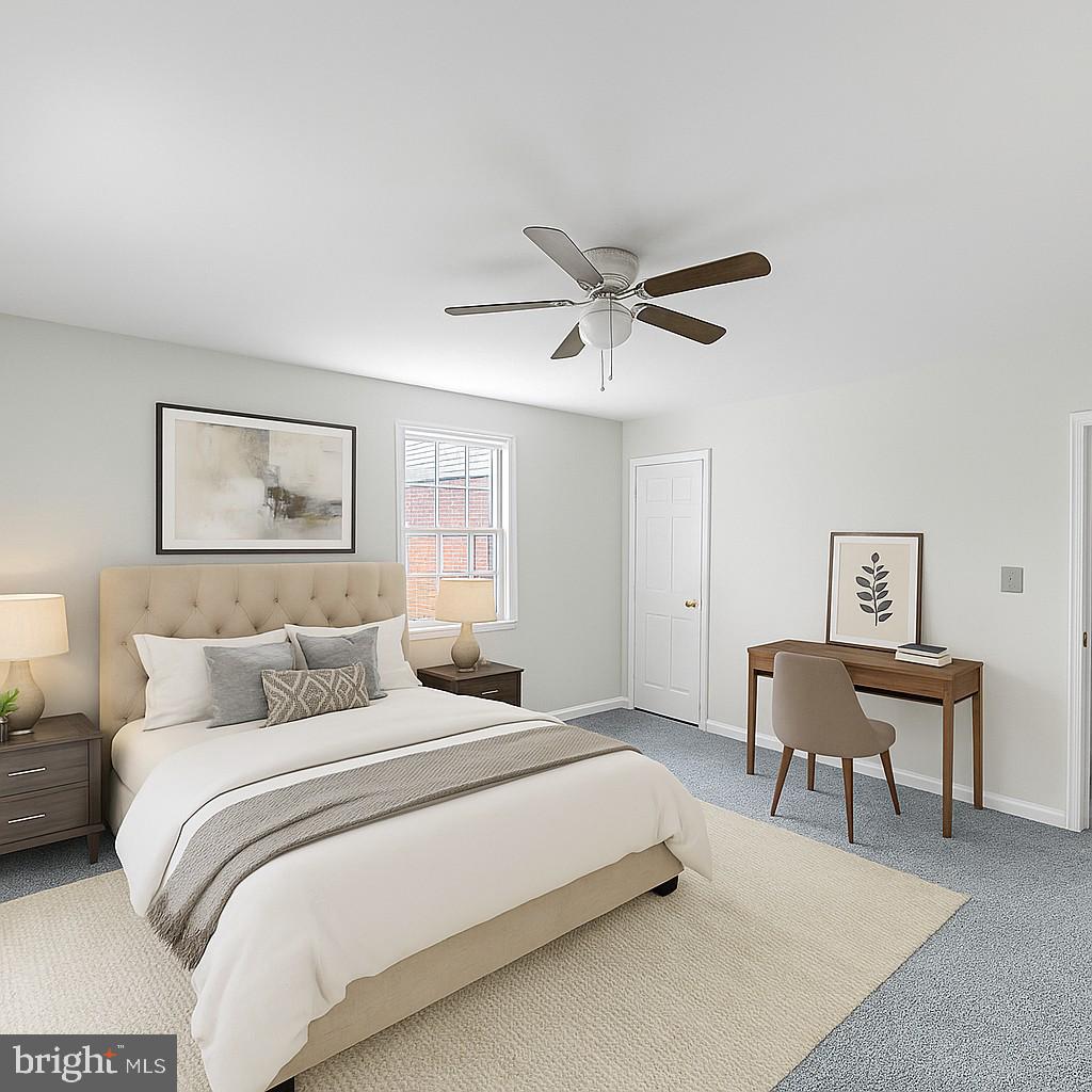 2103 Fort Davis Street Southeast, Unit A Washington, DC 20020 - Photo 8 of 22 a bedroom with a large bed and a chandelier