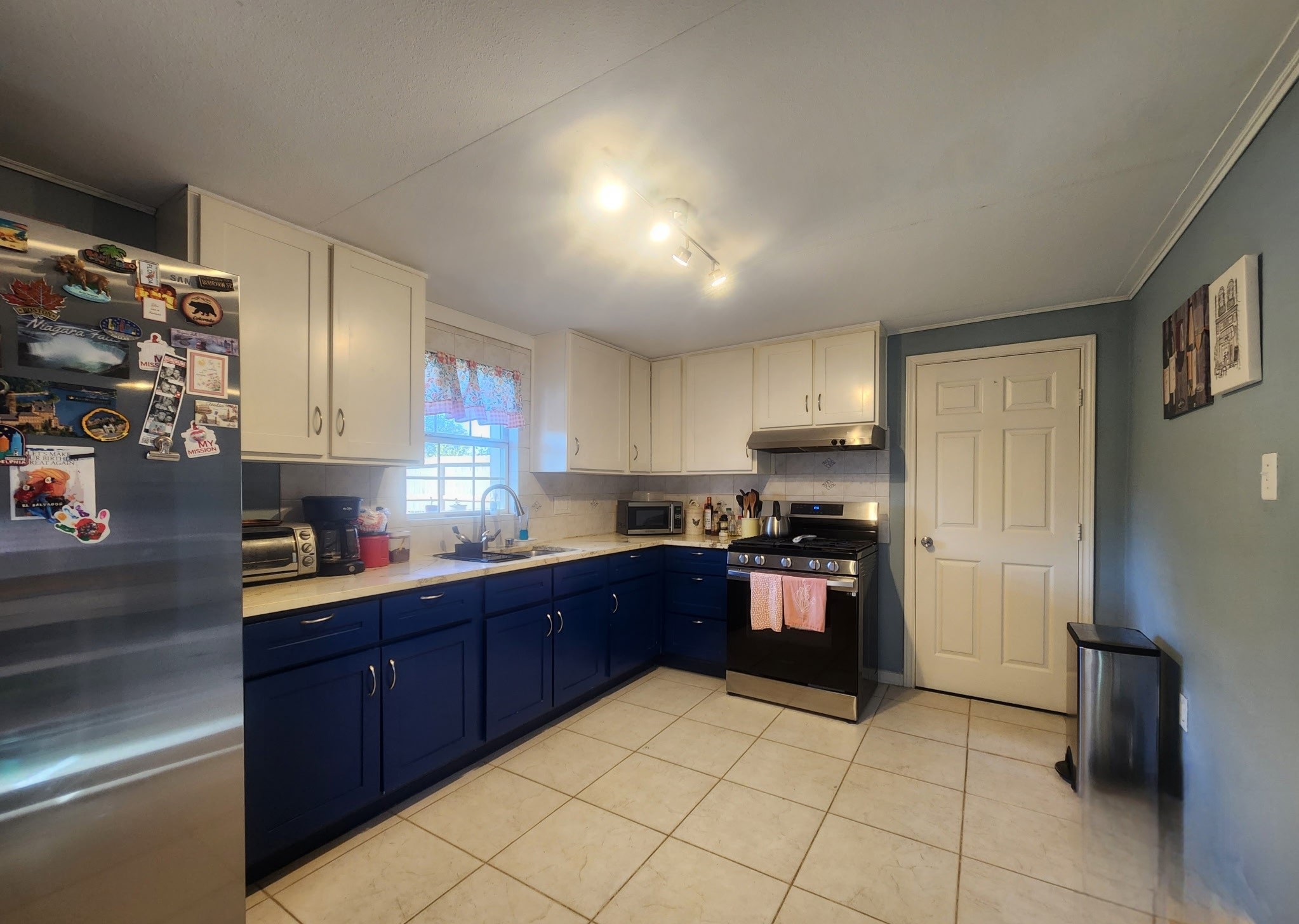 13715 Vickston Lane Houston, TX 77014 - Photo 3 of 12 a kitchen with stainless steel appliances granite countertop a refrigerator and a stove top oven