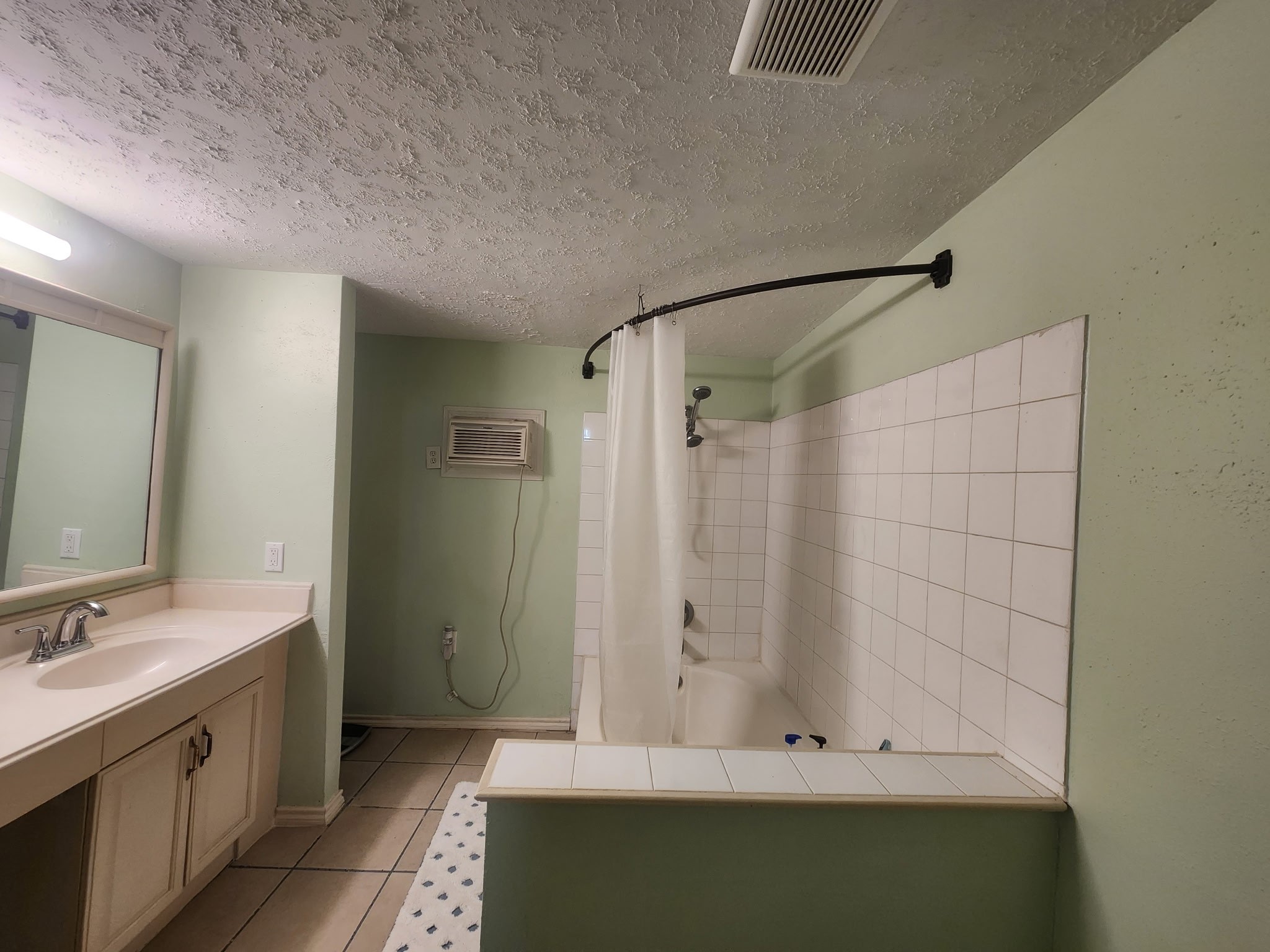 13715 Vickston Lane Houston, TX 77014 - Photo 6 of 12 a bathroom with a bathtub and a sink