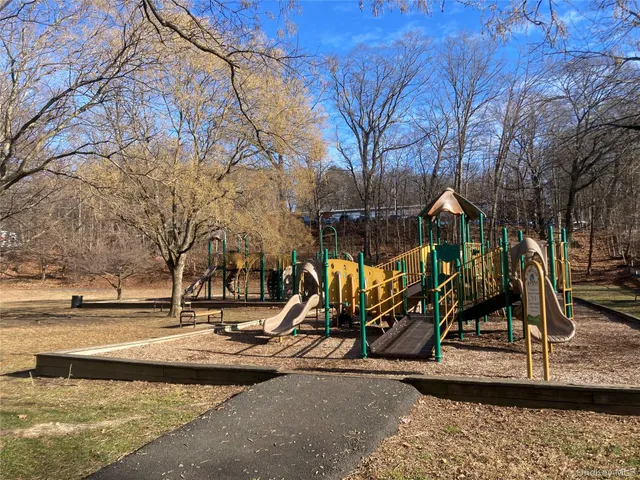 a patio with a table and chairs under an umbrella