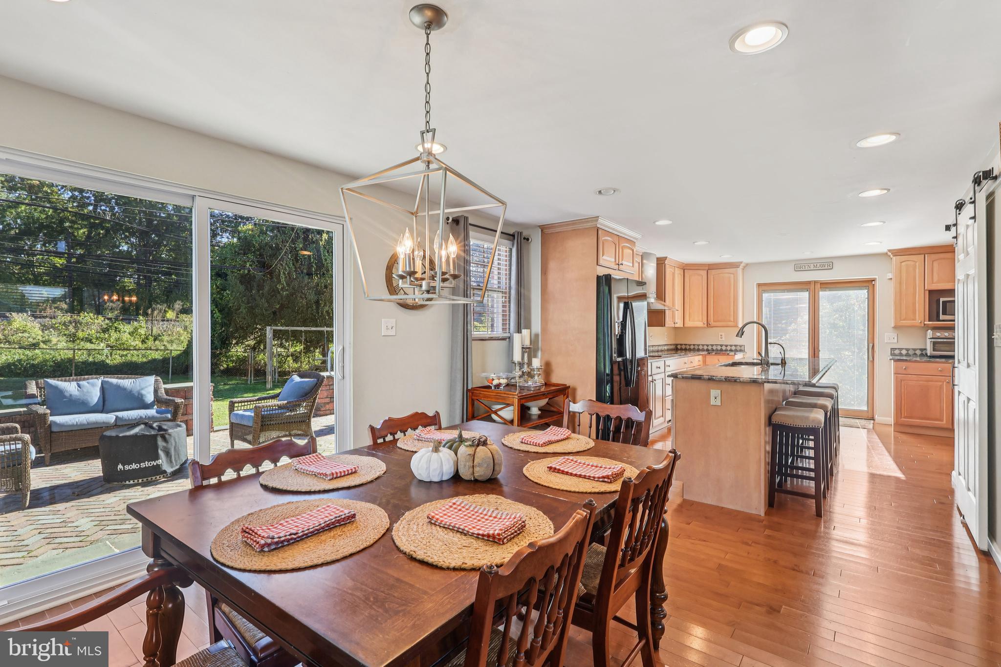 131 Fairfax Road Bryn Mawr, PA 19010 - Photo 7 of 29 a view of a dining room and livingroom with furniture wooden floor a chandelier