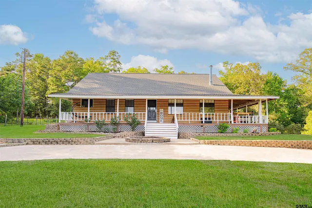 a front view of a house with a yard table and chairs