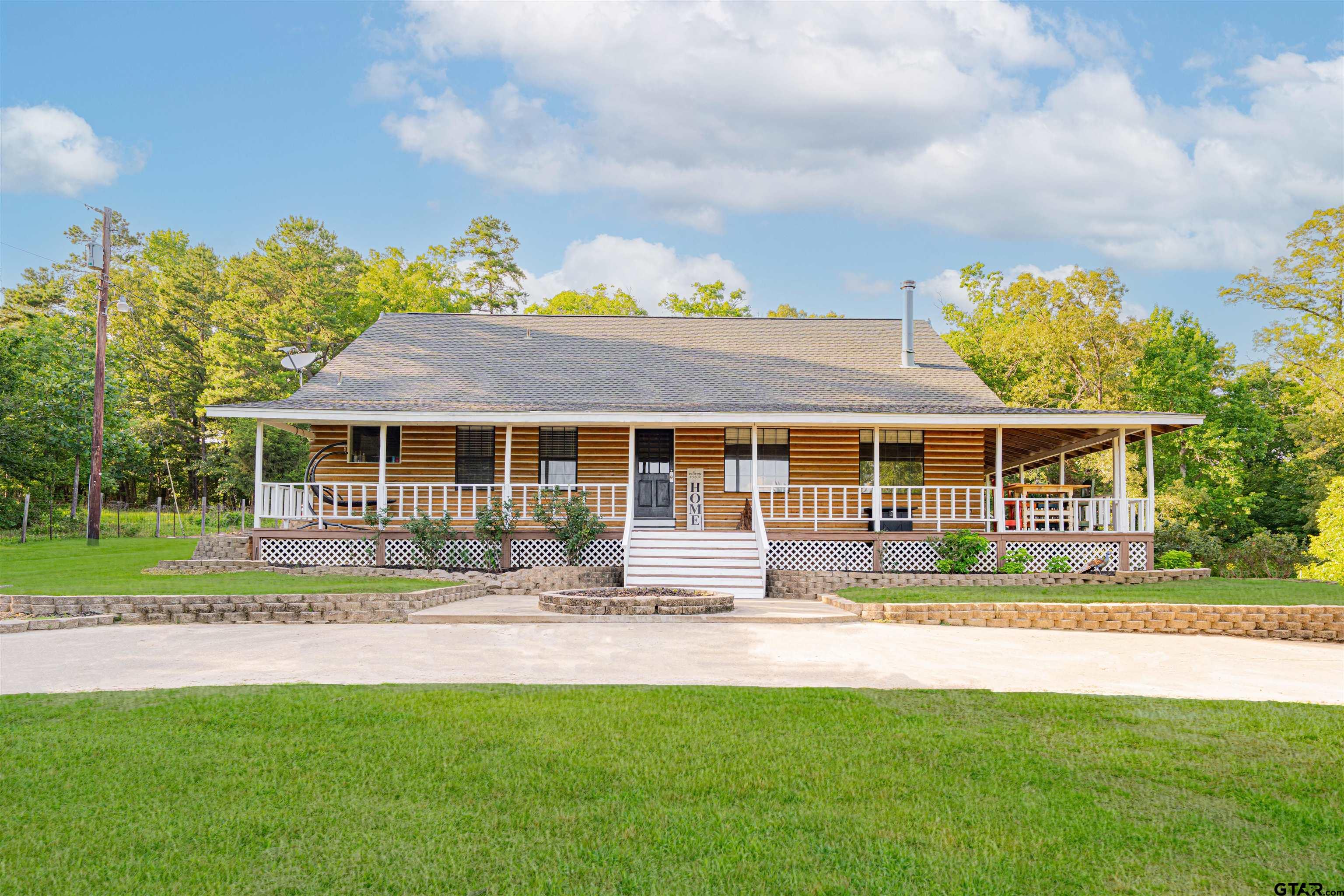 a front view of a house with a yard table and chairs