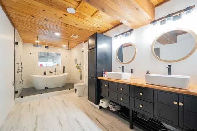 a spacious bathroom with a double vanity sink and a mirror