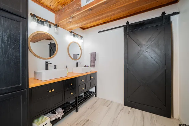 a bathroom with a double vanity sink and a mirror