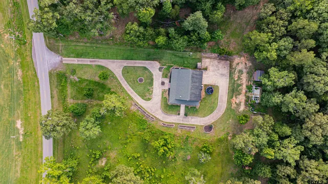 an aerial view of a house with swimming pool outdoor seating and yard