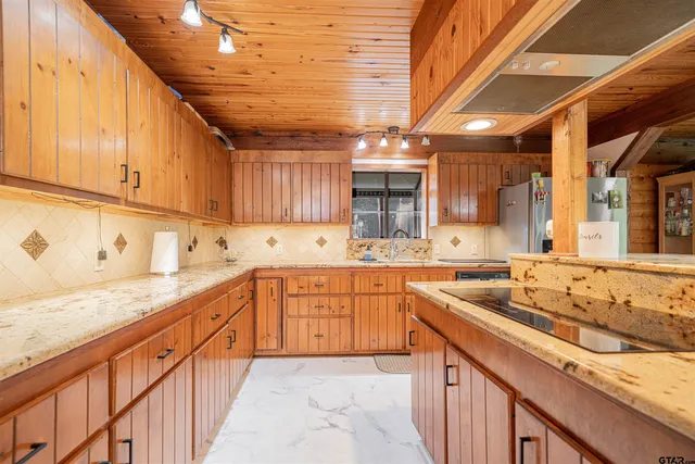 a kitchen with stainless steel appliances granite countertop a sink and cabinets