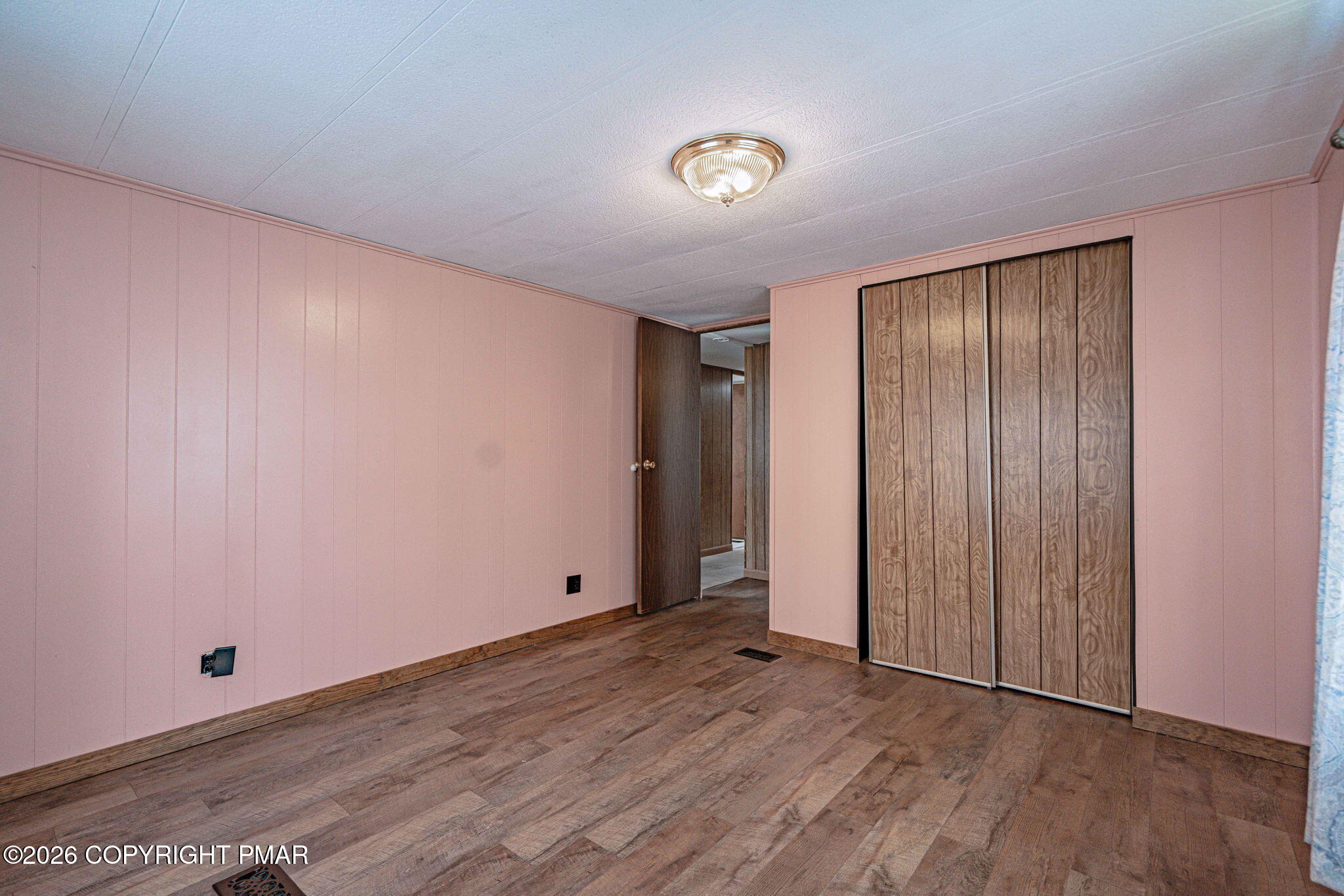 3310 Friedens Road Slatington, PA 18080 - Photo 18 of 38 an empty room with wooden floor and windows