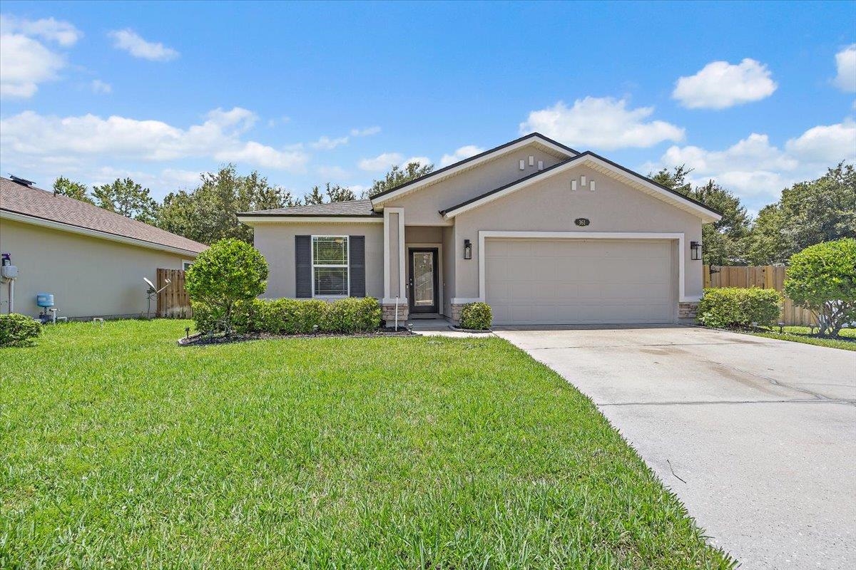 a front view of house with yard and green space