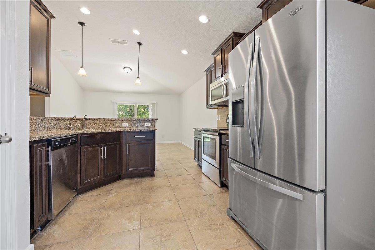 161 Fallen Timber Way St. Augustine, FL 32084 - Photo 4 of 20 a kitchen with stainless steel appliances granite countertop a refrigerator and a sink
