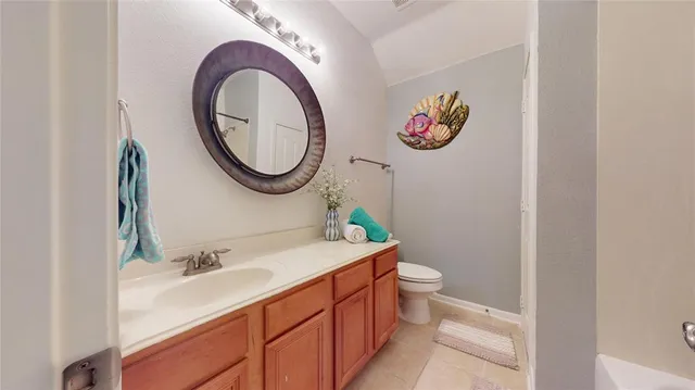 a bathroom with a toilet a sink and a mirror