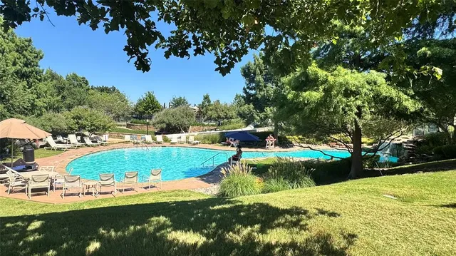 a view of a swimming pool with a yard