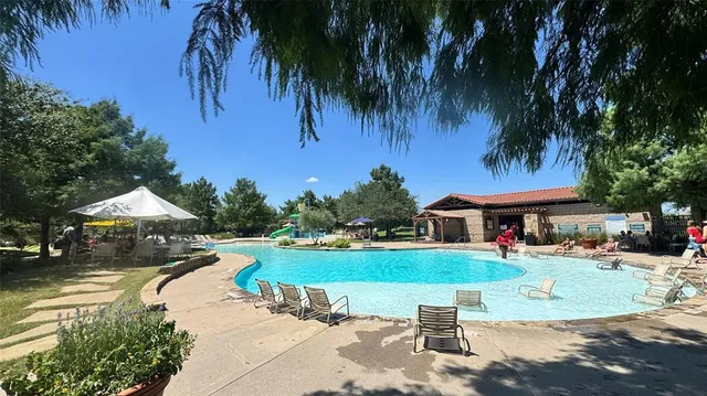 a view of a house with garden and patio
