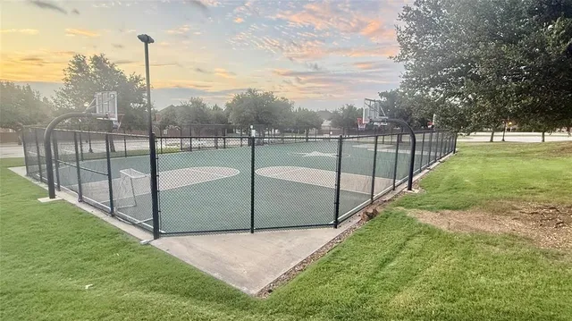 a view of a yard with iron fence