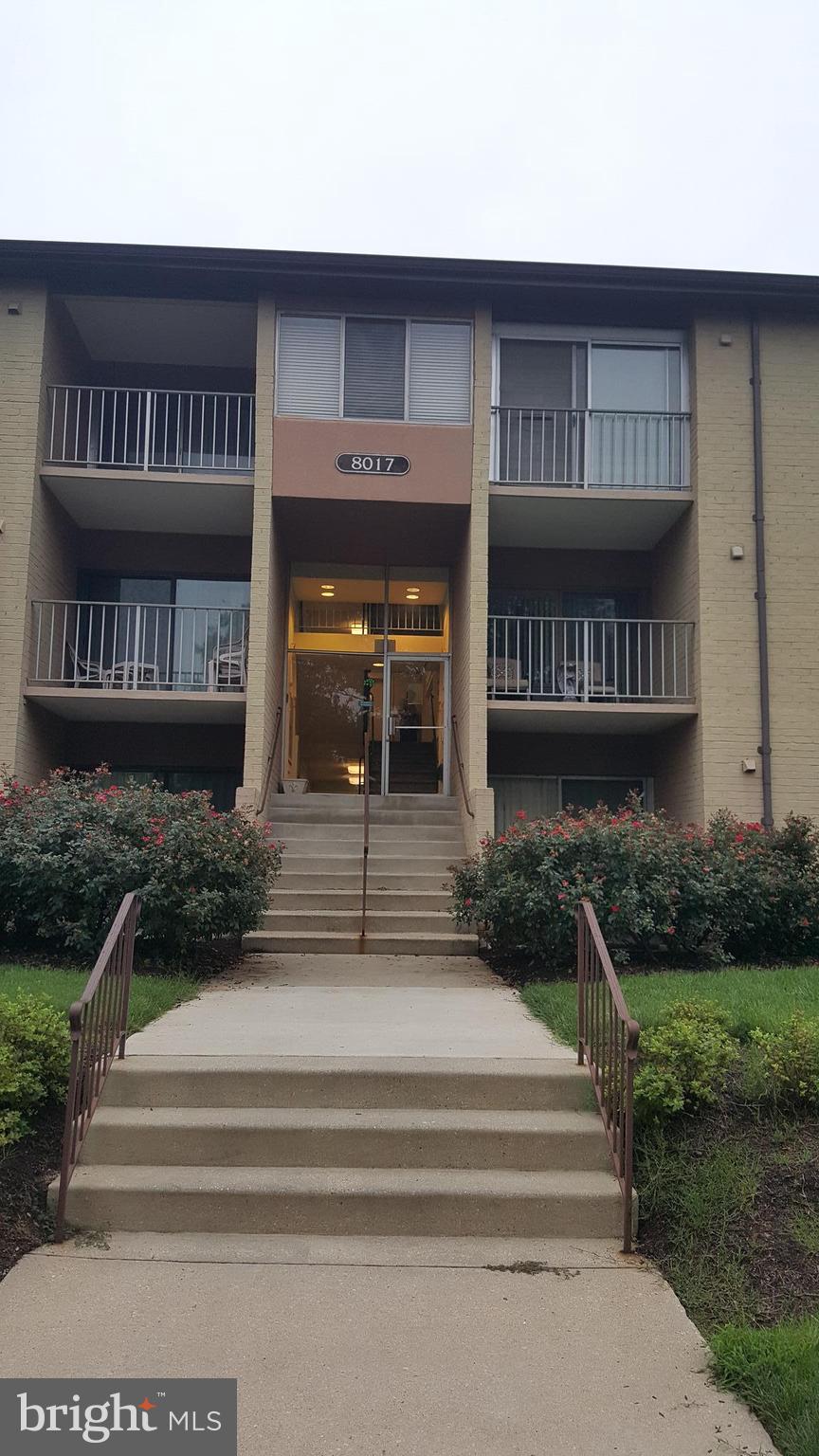 8017 Mandan Road, Unit 302 Greenbelt, MD 20770 - Photo 1 of 7 a front view of a house