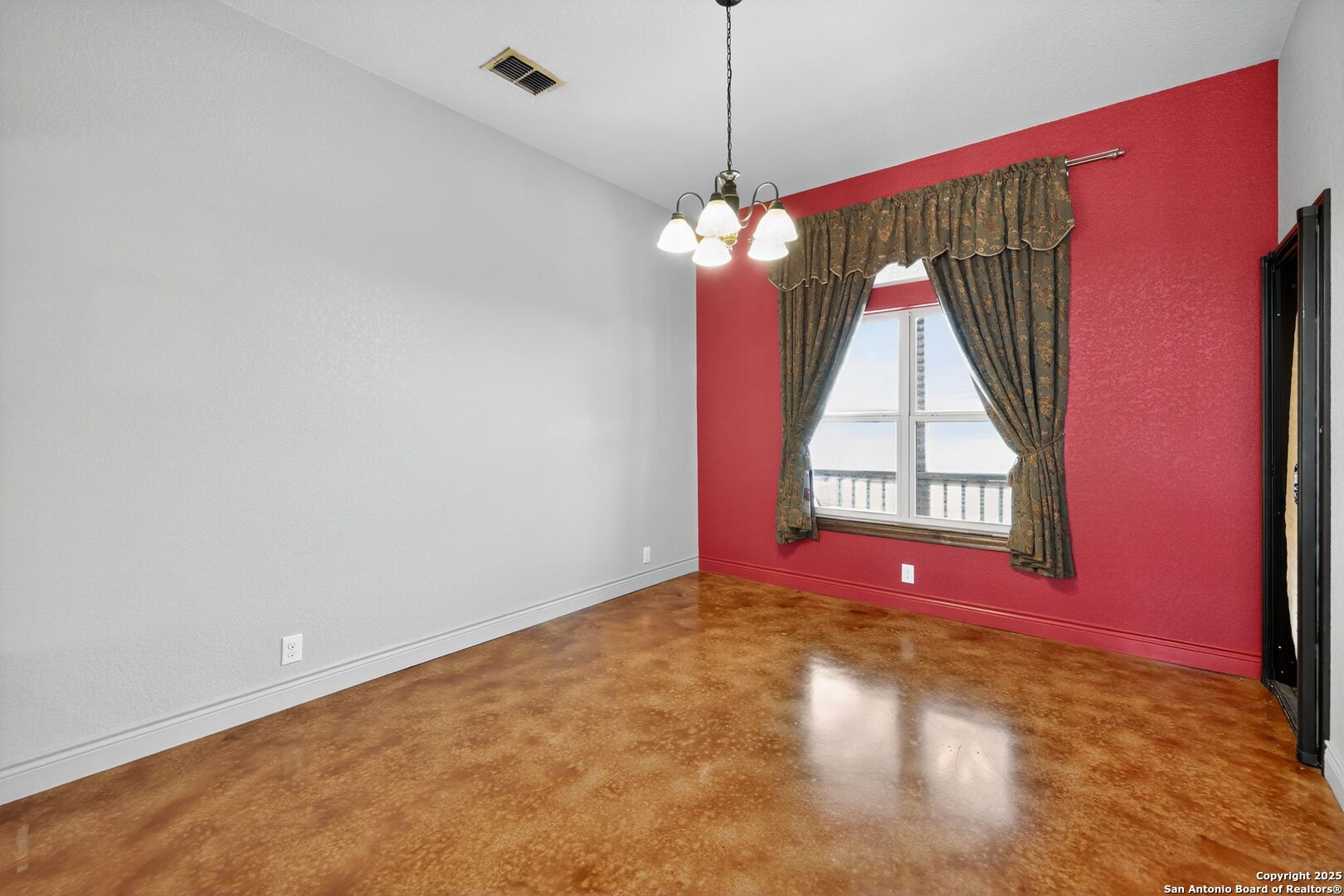 101 Lucky Bandera, TX 78003 - Photo 12 of 42 a view of a room with window chandelier and wooden floor