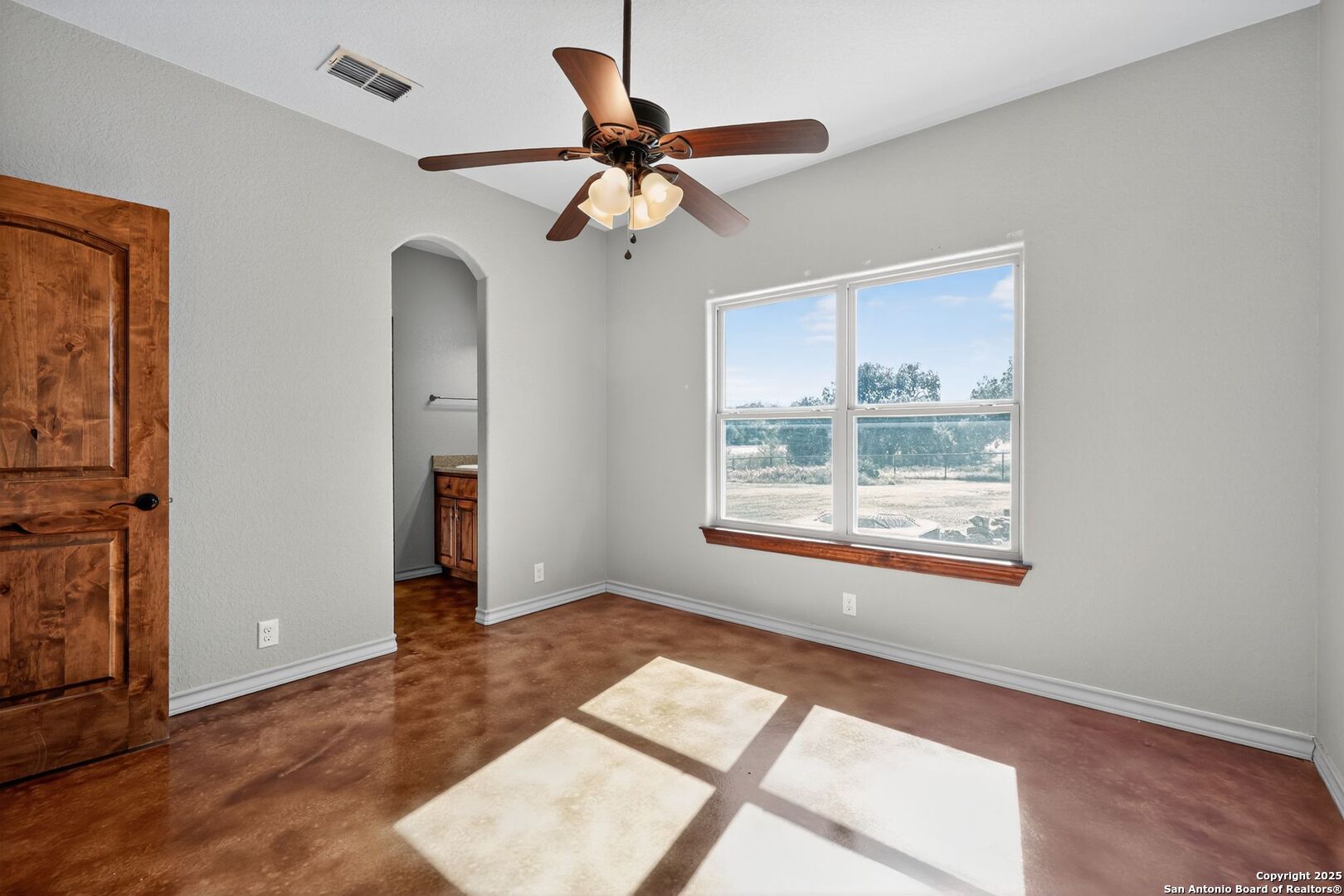 101 Lucky Bandera, TX 78003 - Photo 23 of 42 a view of wooden floor and a chandelier fan in a room