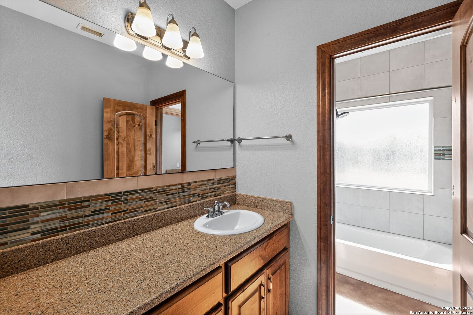 101 Lucky Bandera, TX 78003 - Photo 24 of 42 a bathroom with a sink a light fixture and a mirror