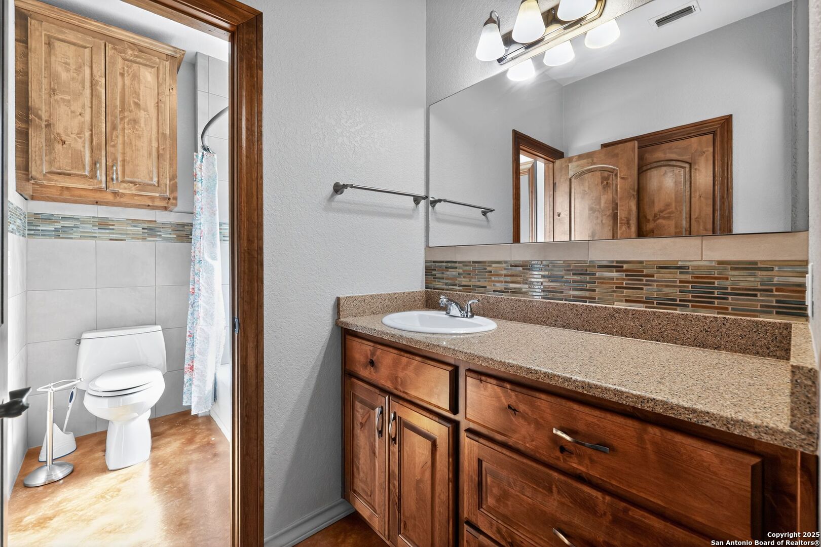 101 Lucky Bandera, TX 78003 - Photo 25 of 42 a bathroom with a sink a toilet and mirror