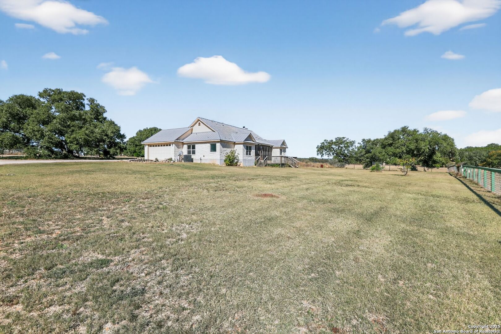 101 Lucky Bandera, TX 78003 - Photo 3 of 42 a view of a large tree with an outdoor space
