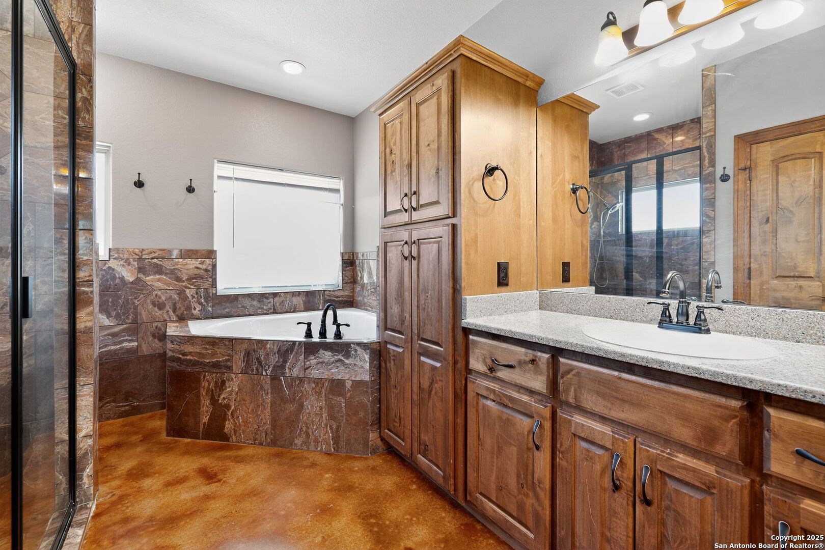 101 Lucky Bandera, TX 78003 - Photo 32 of 42 a bathroom with a granite countertop sink and a mirror