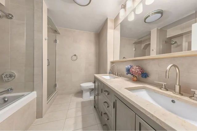 a roof deck with couches and potted plants