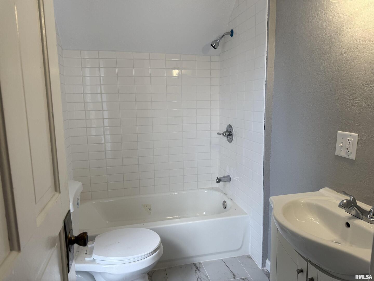 2104 Pershing Boulevard Clinton, IA 52732 - Photo 11 of 14 a bathroom with a bathtub shower sink vanity and toilet