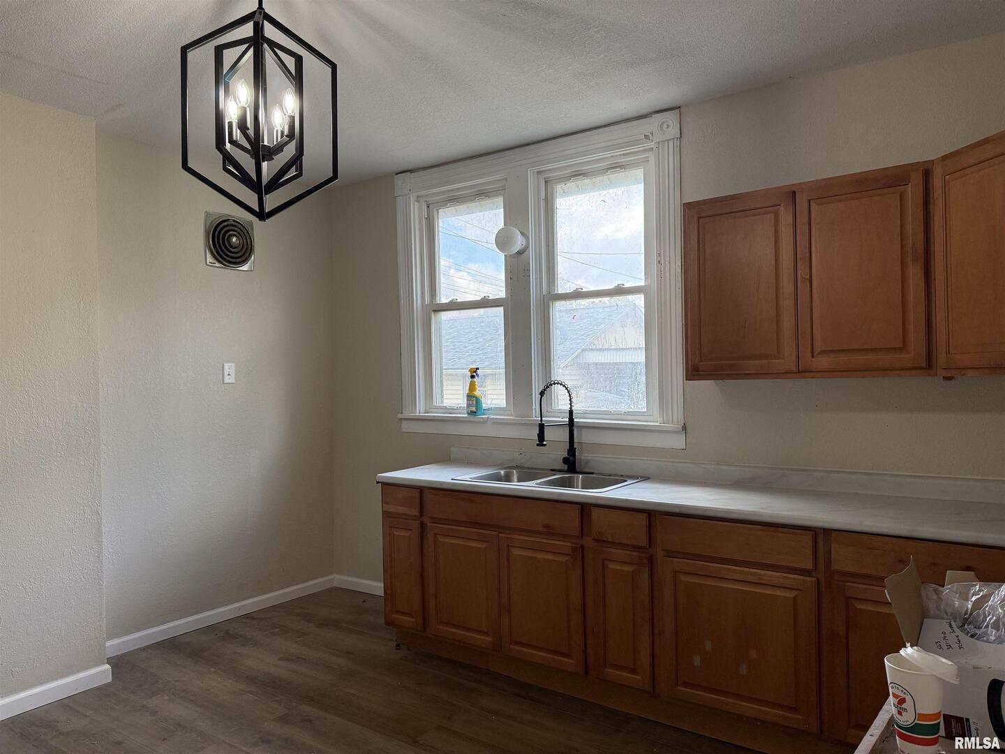 2104 Pershing Boulevard Clinton, IA 52732 - Photo 7 of 14 a kitchen with granite countertop cabinets a window and a sink