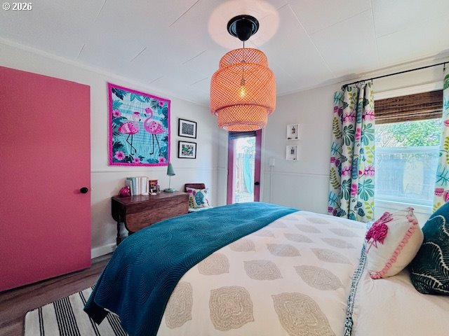 1317 7th Street Florence, OR 97439 - Photo 9 of 29 a bedroom with a bed and a painting on the wall
