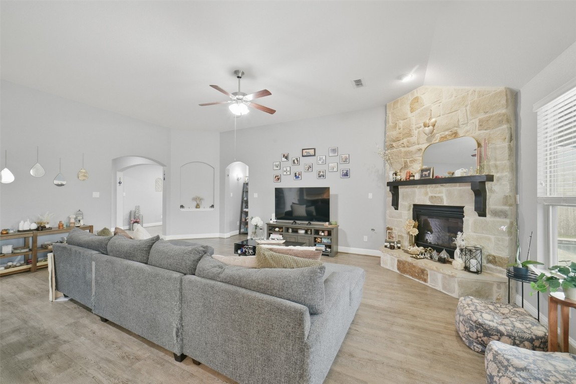 30014 Valley Terrace Drive Fulshear, TX 77406 - Photo 12 of 35 a living room with furniture a fireplace and a chandelier