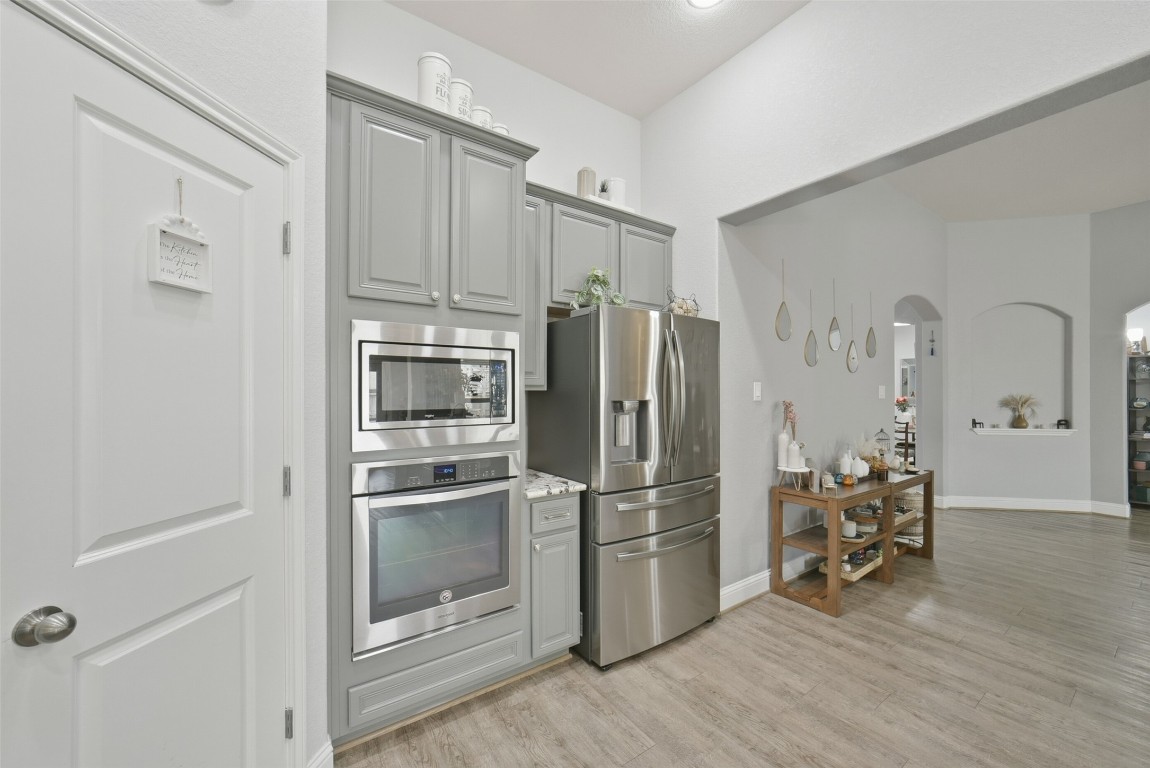 30014 Valley Terrace Drive Fulshear, TX 77406 - Photo 17 of 35 a kitchen with stainless steel appliances a refrigerator and microwave