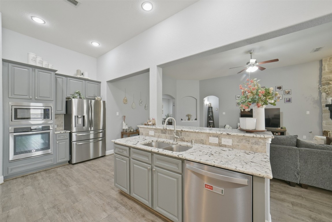 30014 Valley Terrace Drive Fulshear, TX 77406 - Photo 18 of 35 a kitchen with kitchen island a sink stainless steel appliances and window
