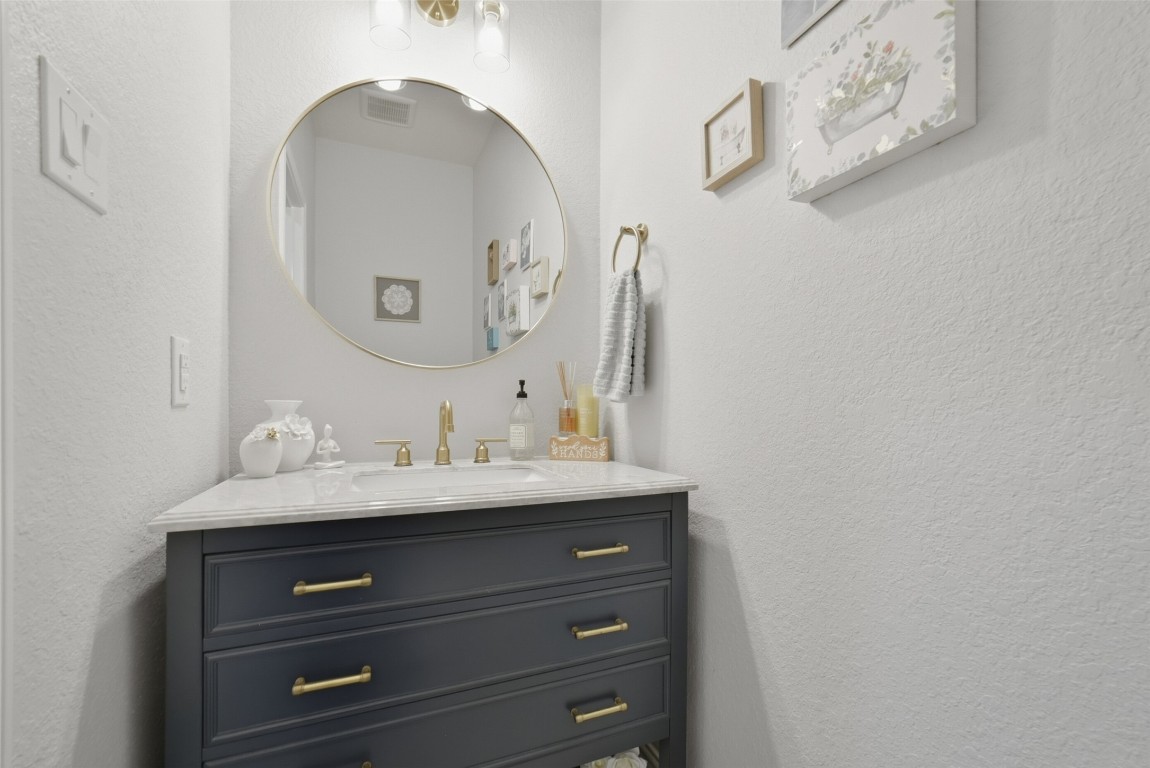 30014 Valley Terrace Drive Fulshear, TX 77406 - Photo 20 of 35 a bathroom with a granite countertop sink and a mirror