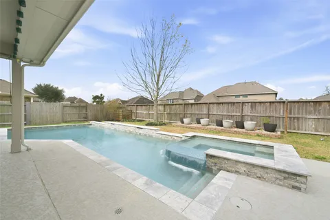 a view of a house with pool and a yard