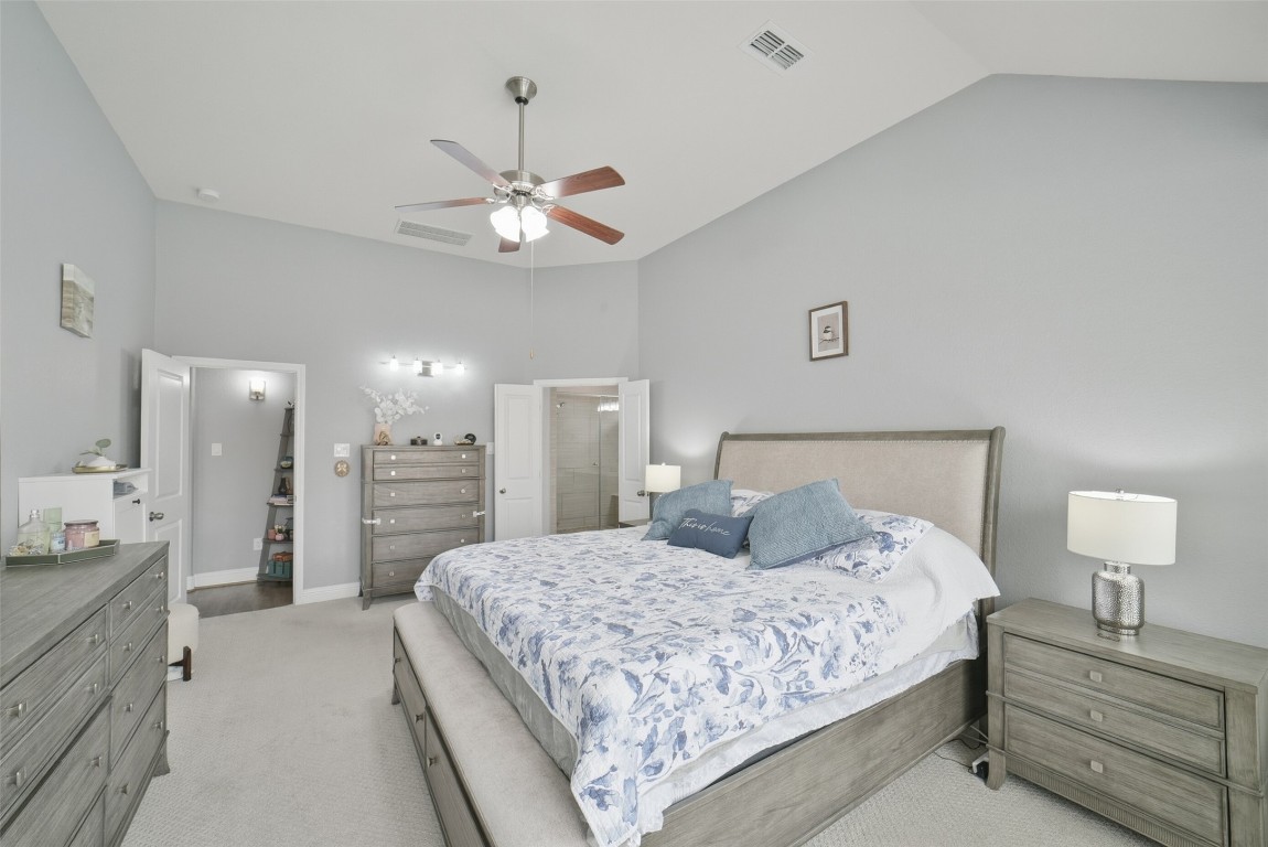 30014 Valley Terrace Drive Fulshear, TX 77406 - Photo 23 of 35 a bedroom with a bed and a chandelier