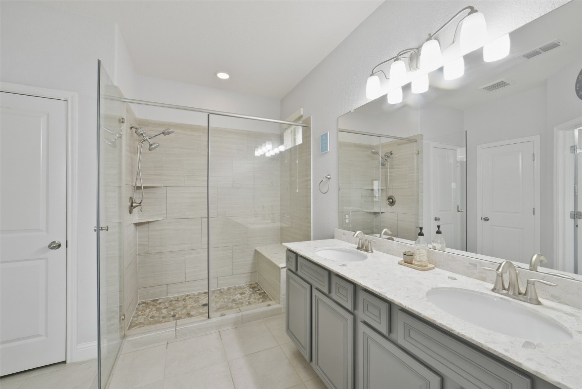 30014 Valley Terrace Drive Fulshear, TX 77406 - Photo 24 of 35 a bathroom with a double vanity sink mirror and shower