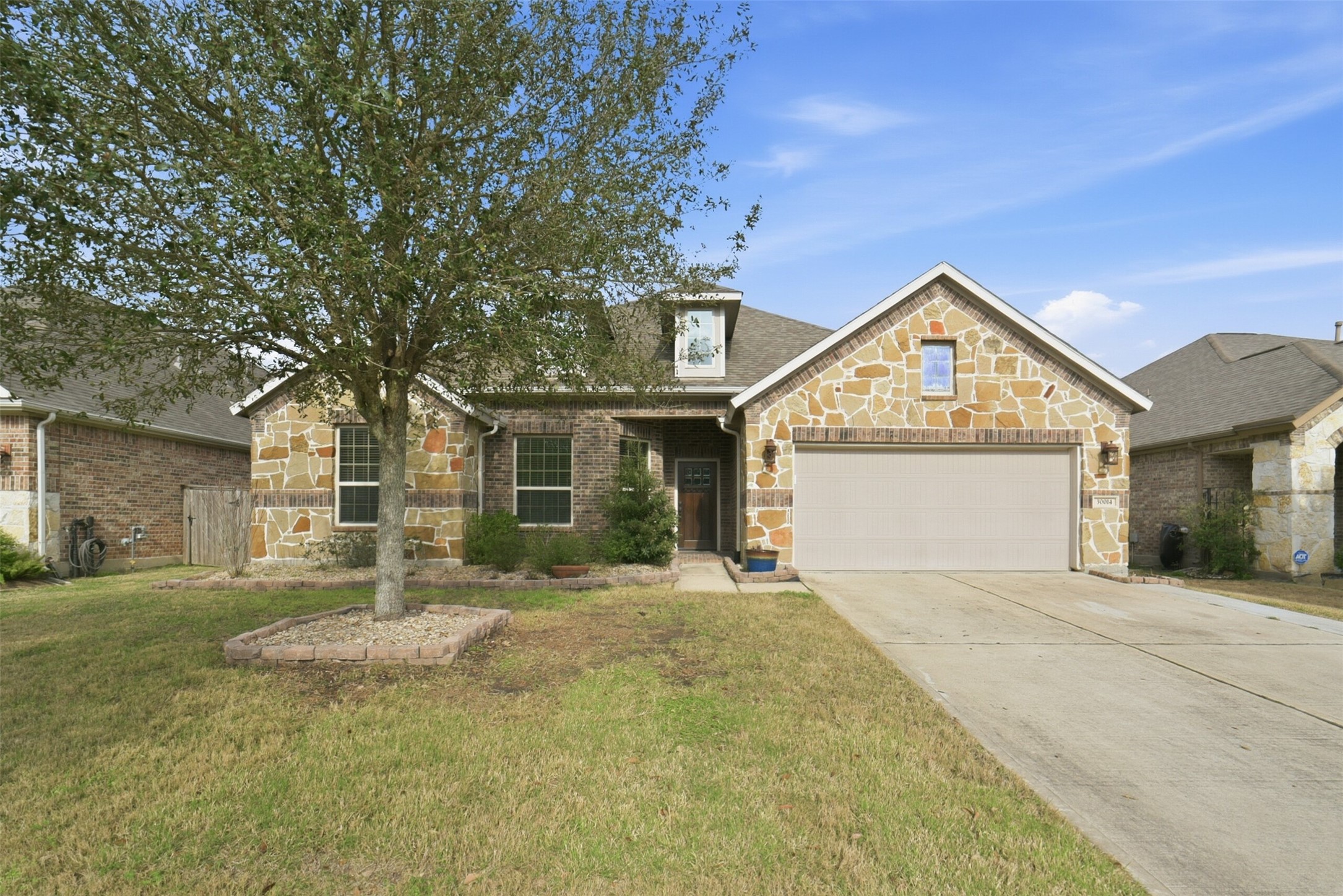 30014 Valley Terrace Drive Fulshear, TX 77406 - Photo 3 of 35 a front view of a house with a yard and garage