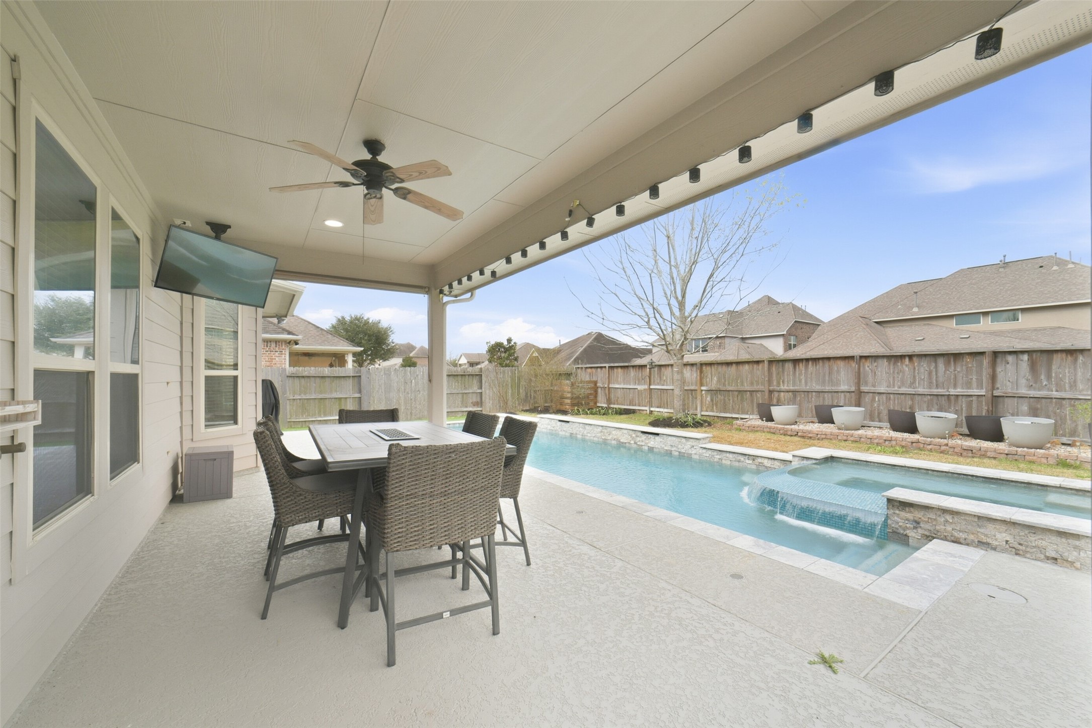 30014 Valley Terrace Drive Fulshear, TX 77406 - Photo 32 of 36 Out back you will find the serene pool/spa, green space and covered patio with ceiling fan.