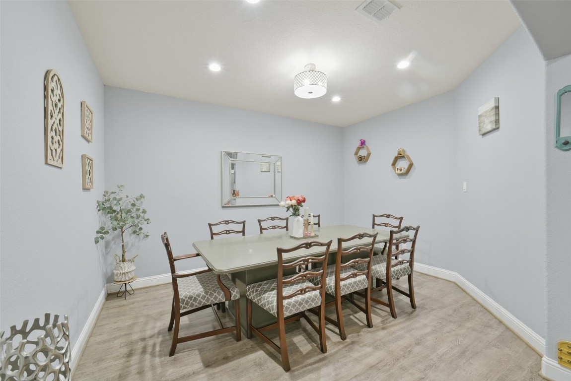 30014 Valley Terrace Drive Fulshear, TX 77406 - Photo 8 of 35 a view of a dining room with furniture and wooden floor