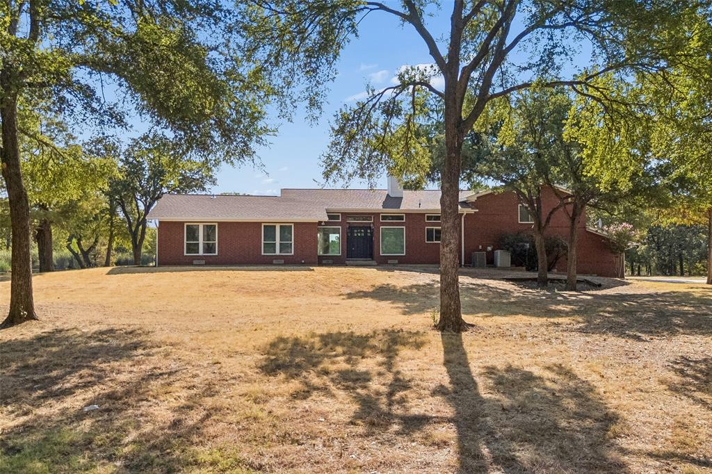 1155 Point Vista Road Hickory Creek, TX 75065 - Photo 16 of 40 Red brick exterior with white trim windows and a dark entry door
