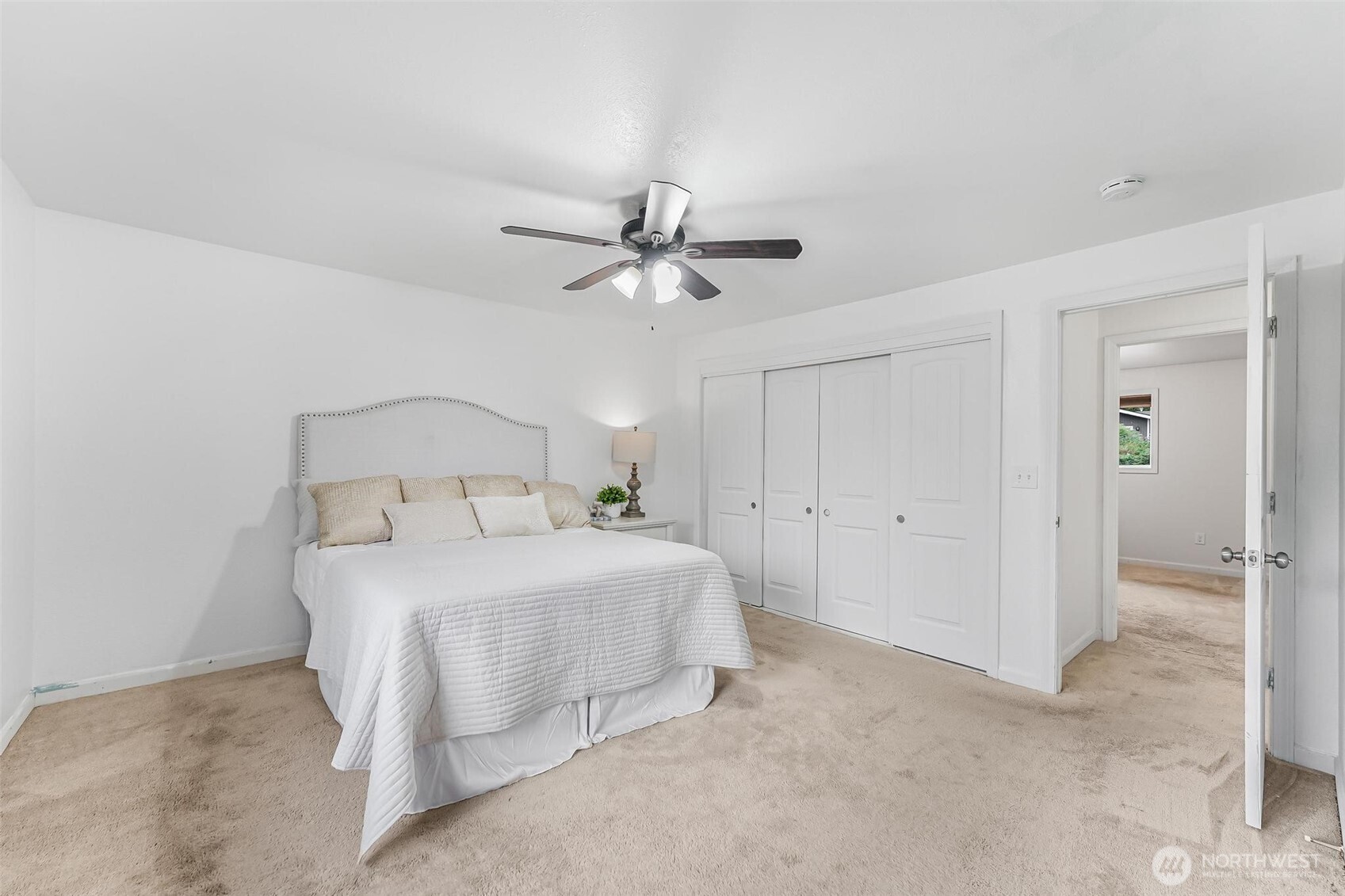 11404 Karshner Road East Edgewood, WA 98372 - Photo 19 of 40 a bedroom with a bed and a ceiling fan