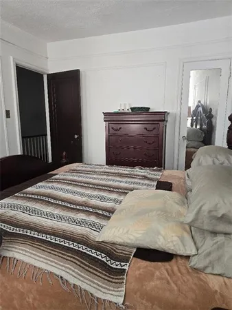 a bedroom with a bed and a television