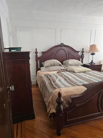 a bedroom with a bed and a night stand
