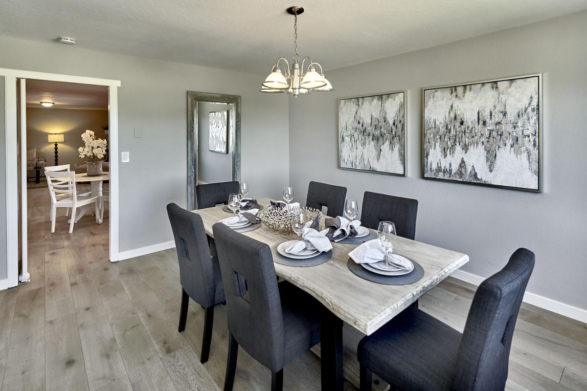 20421 Hunter's Hill Road San Jose, CA 95120 - Photo 17 of 50 a dining room with wooden floor a chandelier a wooden table and chairs