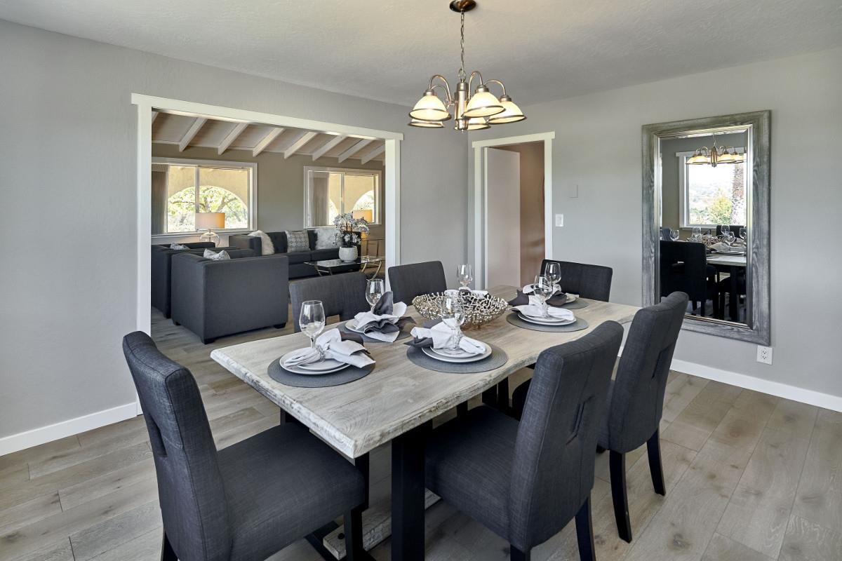 20421 Hunter's Hill Road San Jose, CA 95120 - Photo 18 of 50 a dining room with furniture a chandelier and wooden floor