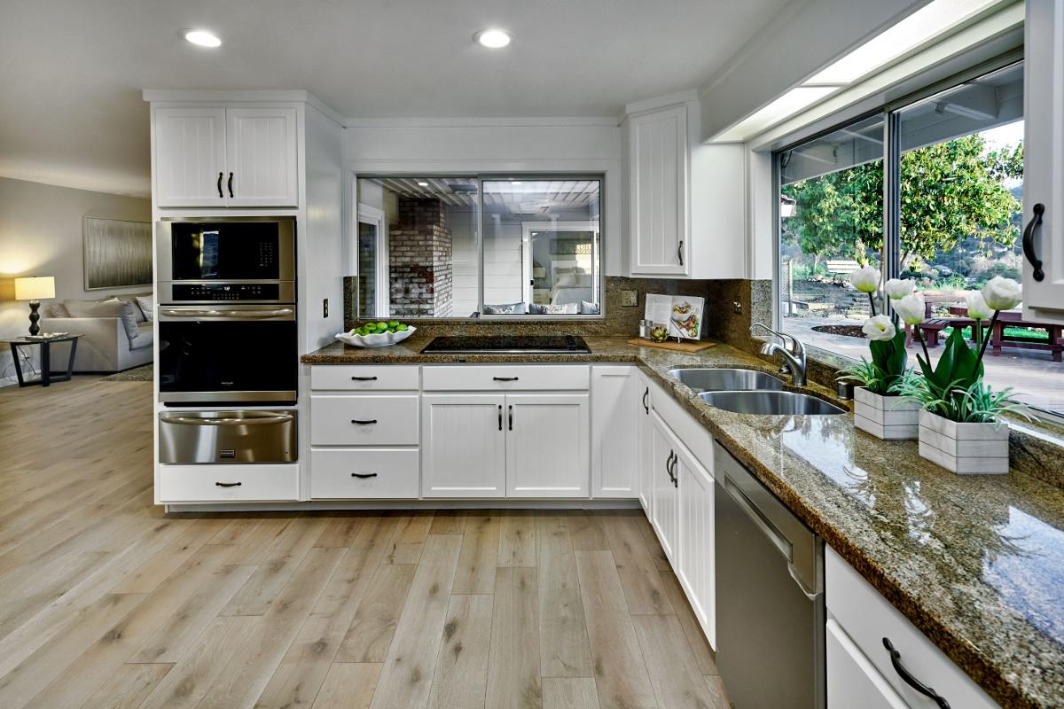 20421 Hunter's Hill Road San Jose, CA 95120 - Photo 21 of 50 a kitchen with stainless steel appliances granite countertop a stove a sink and a microwave