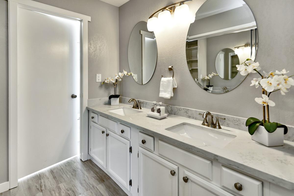 20421 Hunter's Hill Road San Jose, CA 95120 - Photo 32 of 50 a bathroom with double vanity sinks and a mirror