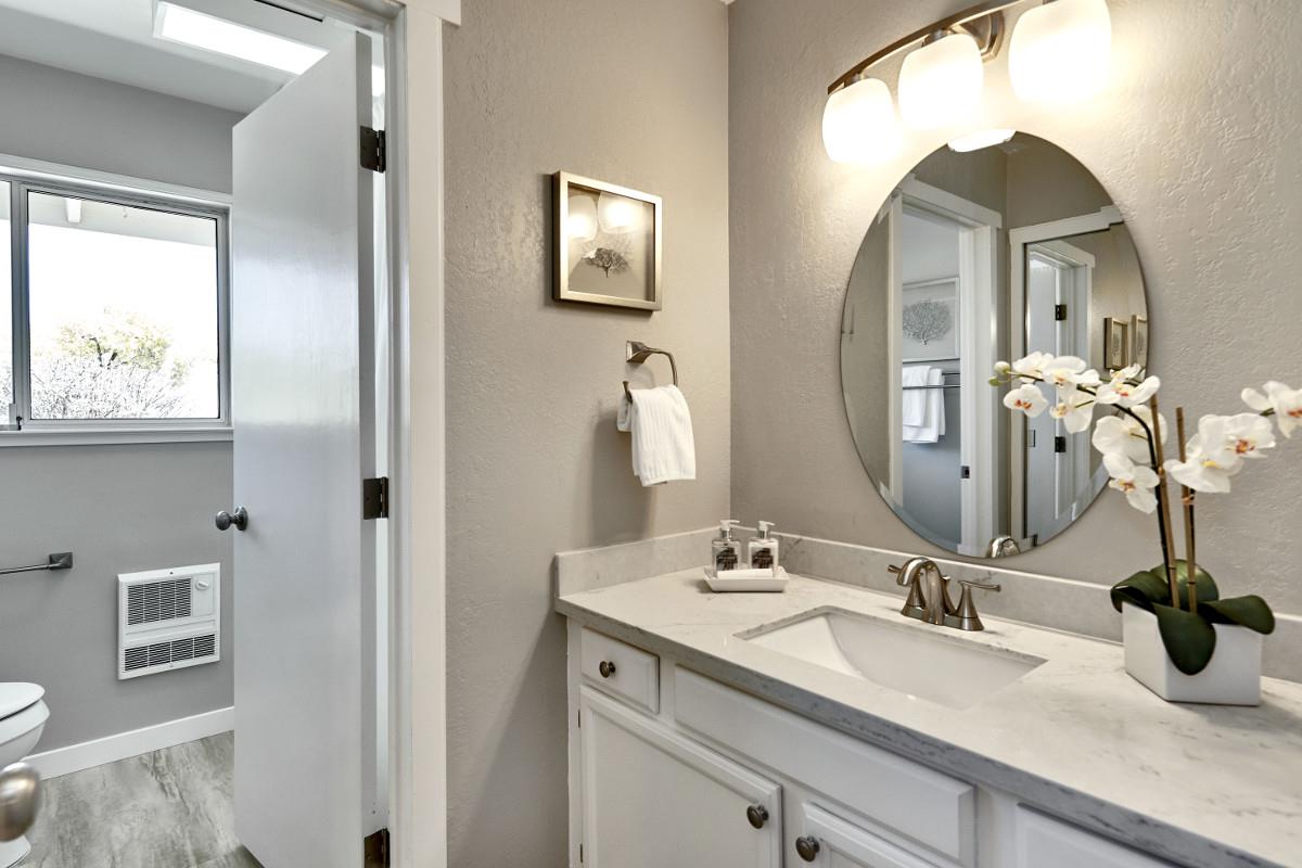 20421 Hunter's Hill Road San Jose, CA 95120 - Photo 36 of 50 a bathroom with a double vanity sink and a mirror